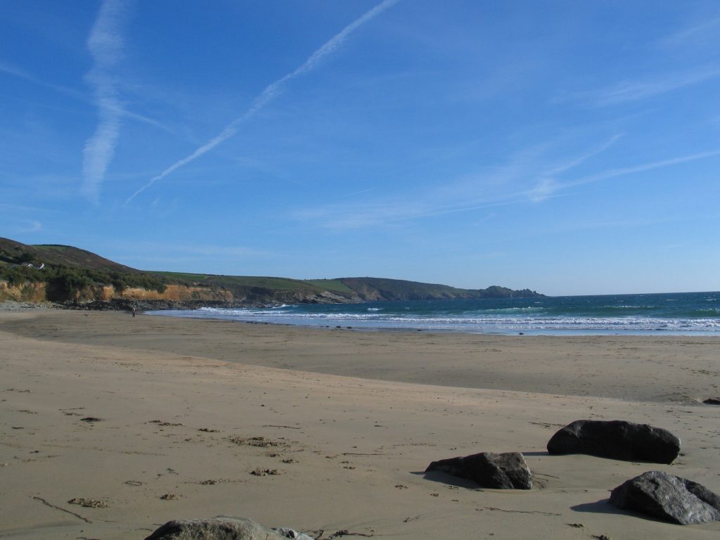 Perranuthnoe beach at low tide in autumn under a perfect blue sky